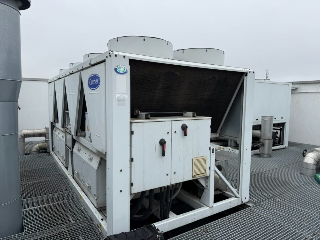 Air-cooled chiller on a factory roof during a service visit