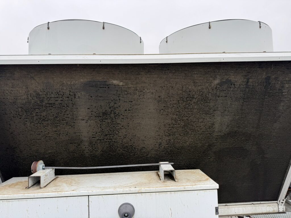 Fouled condenser coil of an air-cooled chiller before cleaning