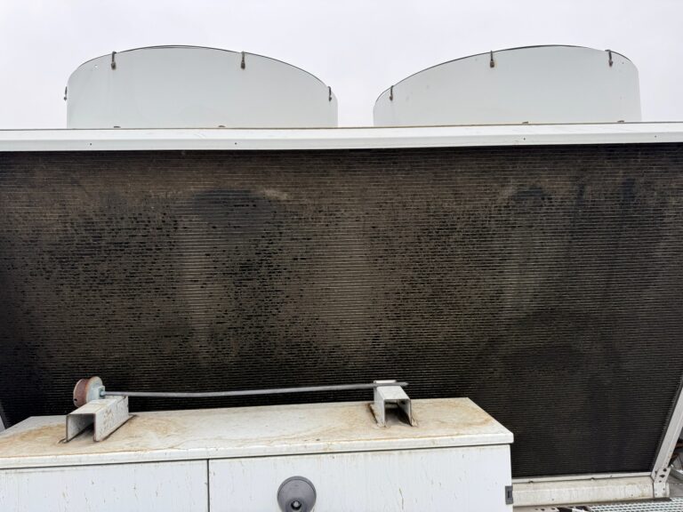 Fouled condenser coil of an air-cooled chiller before cleaning